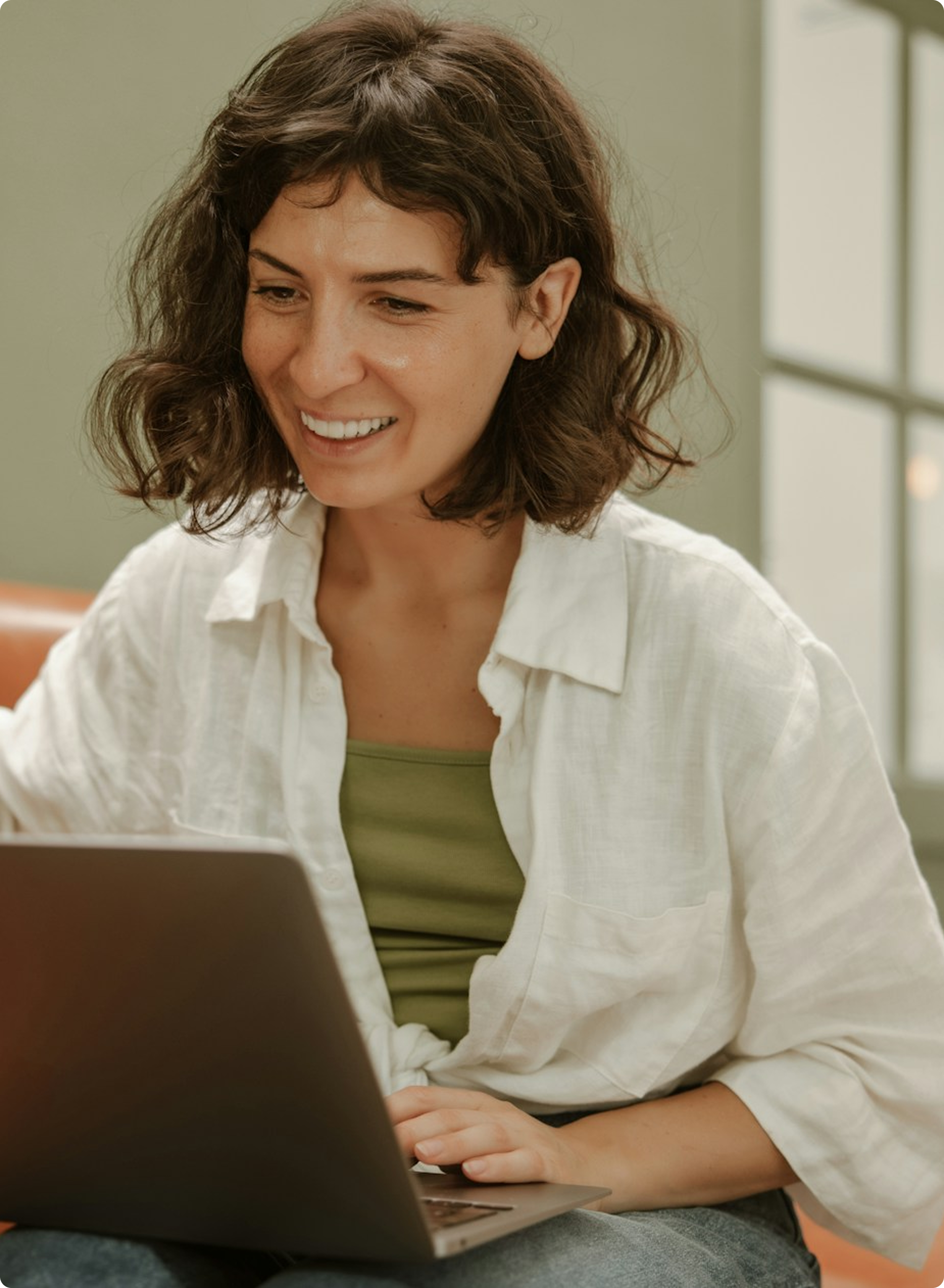 Woman smiling while using laptop
